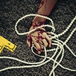 Hand of dead woman holding a pearl necklace --- Image by © Paul Taylor/Corbis